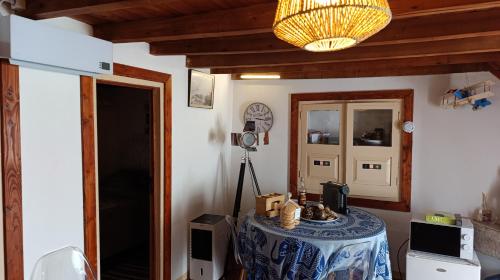a room with a table with a camera and a lamp at Orion Guesthouse Telhado in Fundão