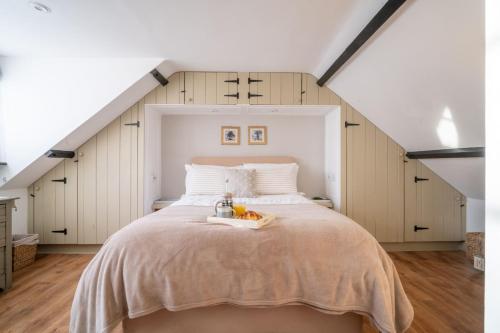 a bedroom with a large bed in a attic at The Old Smithy by Big Skies Cottages in Little Walsingham