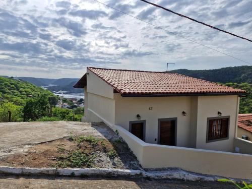 a small white house with a view of a valley at Casa Horizonte do Sertão - Piranhas-AL in Piranhas