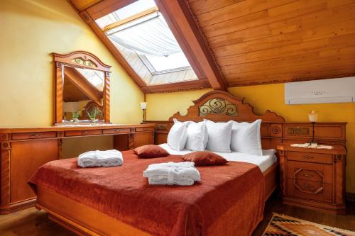 a bedroom with a bed with two towels on it at Koruna in Tatariv