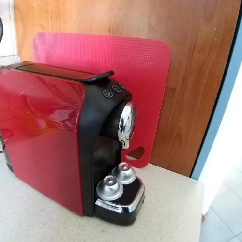 a black and red coffee maker sitting on a counter at monolocale Antica Argenteria stazione e centro a due passi in Vercelli