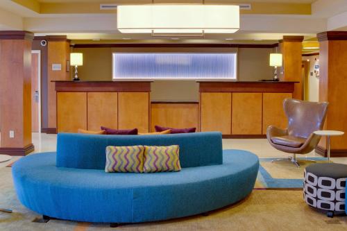 a blue couch in the middle of a lobby at Fairfield by Marriott Inn & Suites Melbourne West/Palm Bay in Melbourne