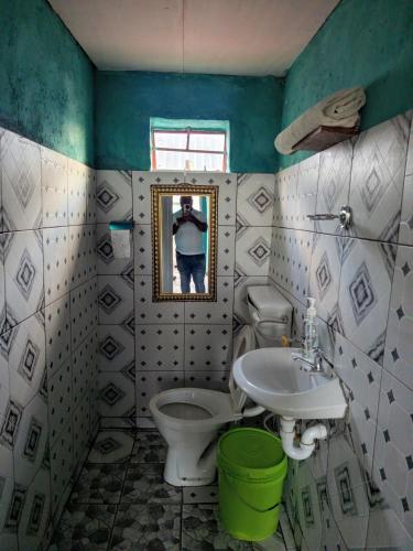a bathroom with a toilet and a sink at Mount Mulanje Stopover in Peremwe