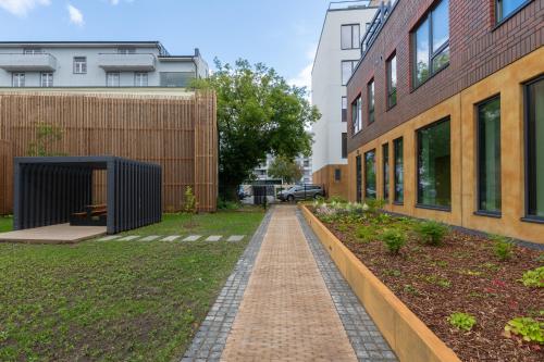 a brick walkway between two buildings in a yard at Revalia Lastekodu-Odra Bus Station Airport Apartments in Tallinn