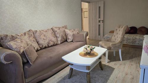 a living room with a couch and a table at Dviejų kambarių butas in Tauragė