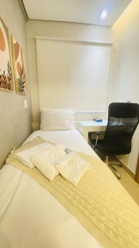 Ένα ή περισσότερα κρεβάτια σε δωμάτιο στο Flats Uberlândia