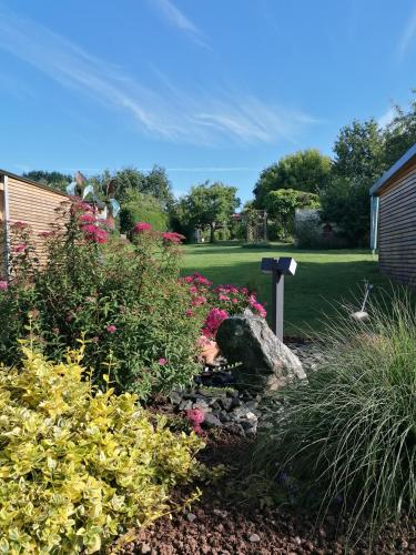 a garden with a rock and flowers in a yard at Ferienhaus MaLu in Nonnweiler