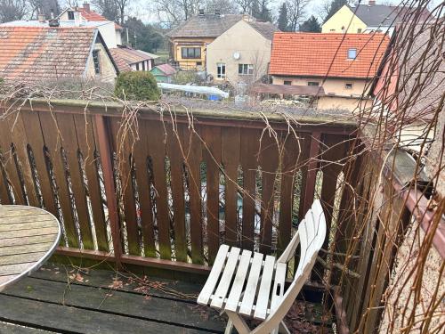 a white bench sitting on top of a balcony at Restaurace a Penzion Podloubí in Opočno