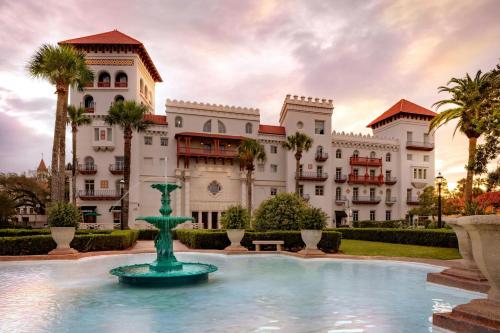 a resort with a fountain in front of a building at Casa Monica Resort & Spa, Autograph Collection in Saint Augustine