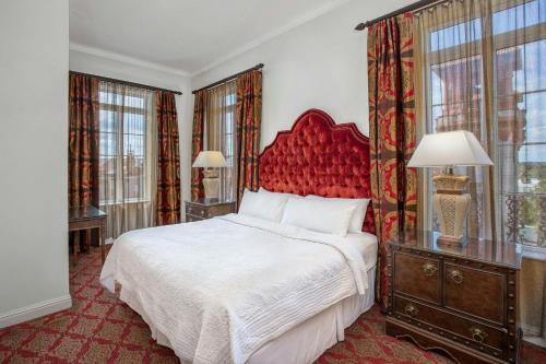 a bedroom with a large bed with a red headboard at Casa Monica Resort & Spa, Autograph Collection in Saint Augustine