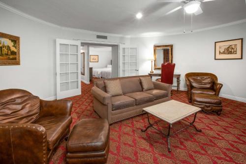 a living room with a couch and chairs and a bed at Casa Monica Resort & Spa, Autograph Collection in Saint Augustine