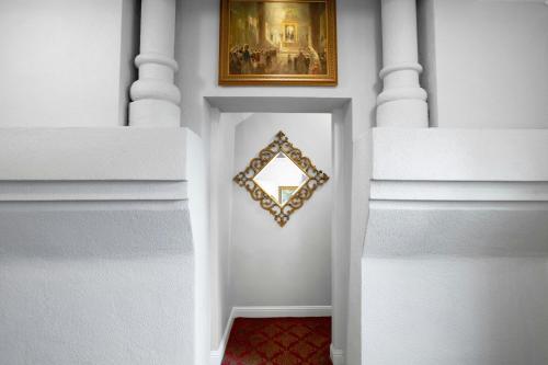 a white hallway with a picture on the wall at Casa Monica Resort & Spa, Autograph Collection in Saint Augustine