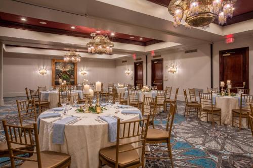 a banquet room with tables and chairs and chandeliers at Casa Monica Resort & Spa, Autograph Collection in Saint Augustine