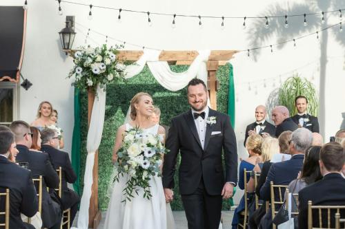 a bride and groom walking down the aisle at their wedding ceremony at Casa Monica Resort & Spa, Autograph Collection in Saint Augustine