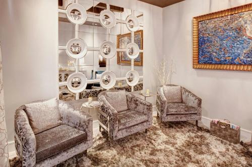 a living room with two chairs and a chandelier at Casa Monica Resort & Spa, Autograph Collection in Saint Augustine