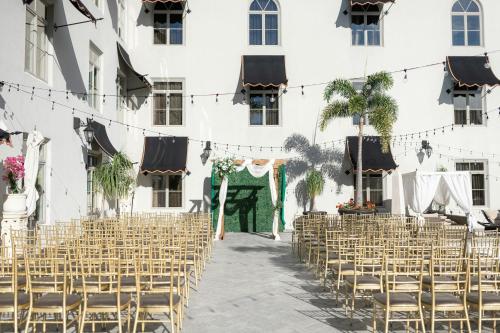 a wedding ceremony in the courtyard of a building at Casa Monica Resort & Spa, Autograph Collection in Saint Augustine