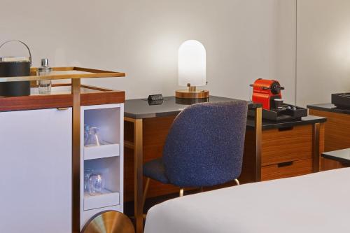 a room with a desk and a blue chair at W Minneapolis - The Foshay in Minneapolis