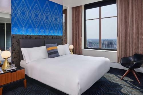 a hotel room with a large bed and a window at W Minneapolis - The Foshay in Minneapolis
