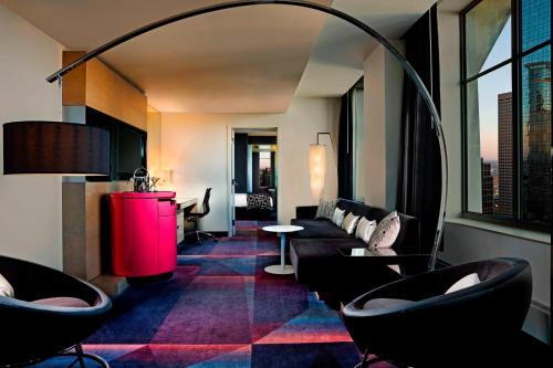 a living room with a couch and a table at W Minneapolis - The Foshay in Minneapolis
