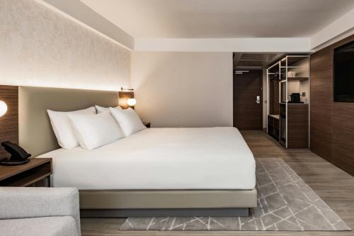 a hotel room with a bed and a couch at AC Hotel by Marriott St Julian's in St Julian's