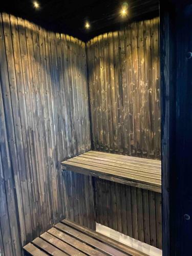 a sauna with two wooden shelves in a room at Delicious pool villa near Tylösand in Halmstad