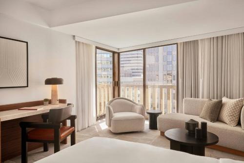 a living room with a couch and a chair and a desk at The Jay, Autograph Collection in San Francisco