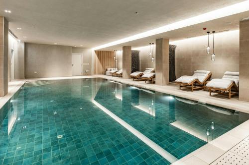a large swimming pool in a hotel room at AC Hotel by Marriott St Julian's in St Julian's