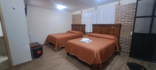 Postel nebo postele na pokoji v ubytování Cabaña La Hacienda 1
