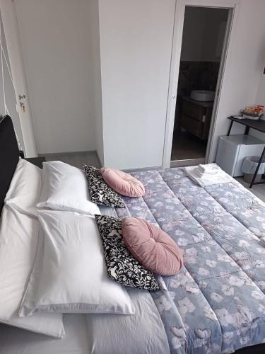 a bed with pillows on it in a bedroom at B&B Ginevra in Porto San Giorgio
