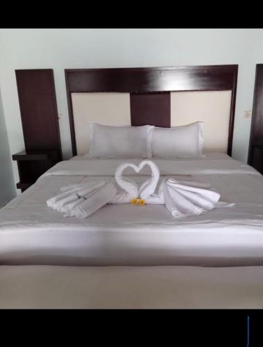 a bed with two towels in the shape of a heart at Amoryg Resort and Dive Raja Ampat in Pulau Mansuar