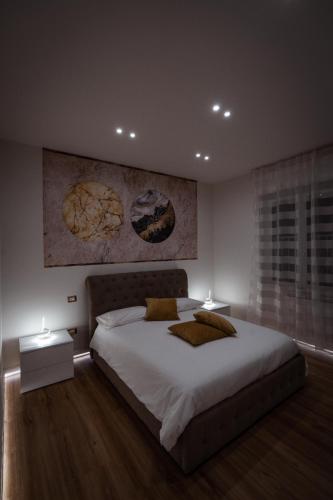 a bedroom with a large bed and two lamps at Mar House & Suites Guest House in Castellammare di Stabia