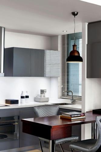 a kitchen with a table and some chairs in it at Le Meridien Istanbul Etiler in Istanbul