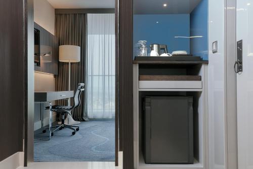 a door leading into a room with a desk at Le Meridien Istanbul Etiler in Istanbul