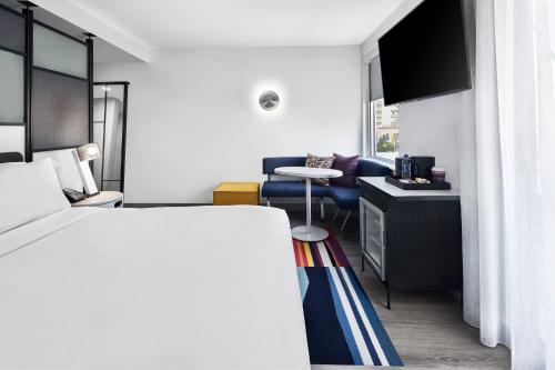 a hotel room with a bed and a living room at Aloft Ocean City in Ocean City