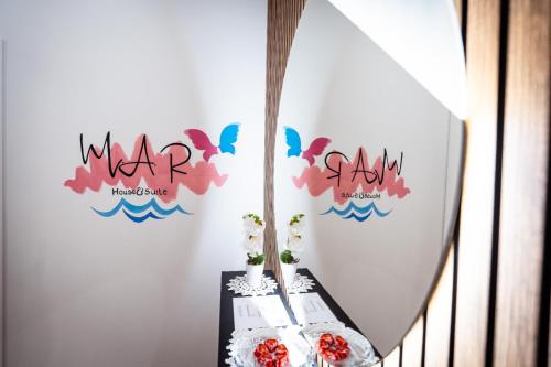 a table with two cakes and butterflies on the wall at Mar House & Suites Guest House in Castellammare di Stabia