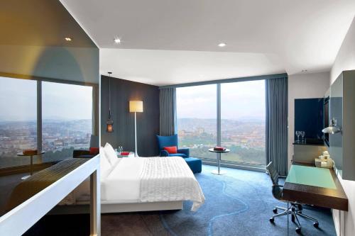 a hotel room with a bed and a desk at Le Meridien Istanbul Etiler in Istanbul