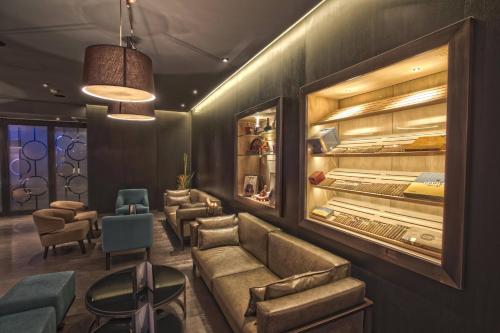 a waiting room with a couch and chairs at Le Meridien Istanbul Etiler in Istanbul