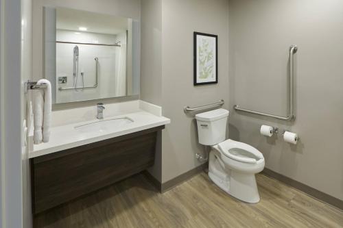 a bathroom with a sink and a toilet at TownePlace Suites by Marriott Hamilton in Hamilton