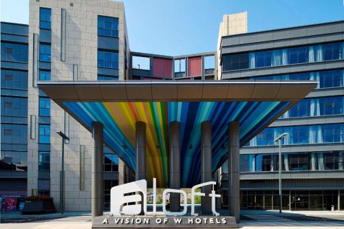 a view of a building with a rainbow at Aloft Dongguan Songshan Lake in Dongguan