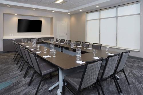 a large conference room with a long table and chairs at TownePlace Suites by Marriott Hamilton in Hamilton