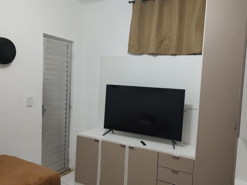 a flat screen tv sitting on top of a cabinet at Studio 202 Cop 30 in Belém