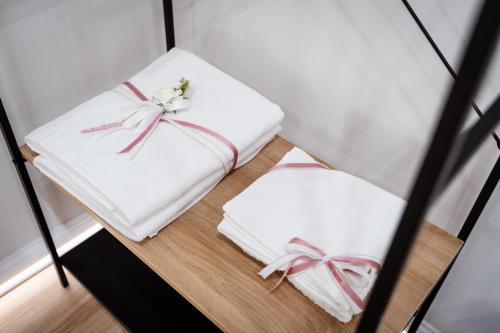 two white towels on a shelf with bows at Mar House & Suites Guest House in Castellammare di Stabia