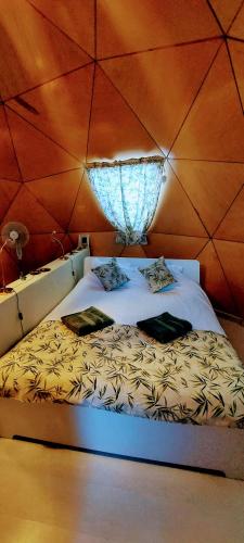 a large bed in a room with a wall at vale das cupulas in Figueiró dos Vinhos