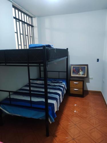 a bedroom with two bunk beds and a television at no disponibl in Trujillo