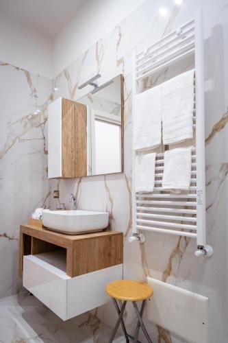 a bathroom with a sink and a mirror at Mar House & Suites Guest House in Castellammare di Stabia