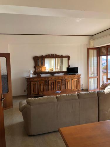 a living room with a couch and a mirror at Ardor Domus in Ardore Marina