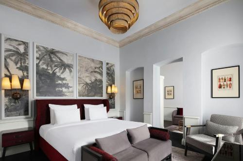 a hotel room with a bed and a chair at Adahan DeCamondo Pera, Autograph Collection in Istanbul