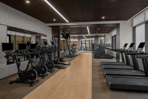 a gym with rows of treadmills and exercise bikes at AC Hotel by Marriott Washington DC Capitol Hill Navy Yard in Washington, D.C.