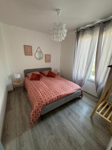 a bedroom with a bed and a chandelier at Chez Brunella Reims centre avec parking in Reims
