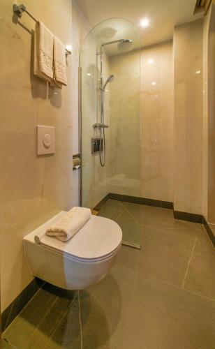 a bathroom with a toilet and a shower at DUO by CASEPIA Hotel in Phu Quoc